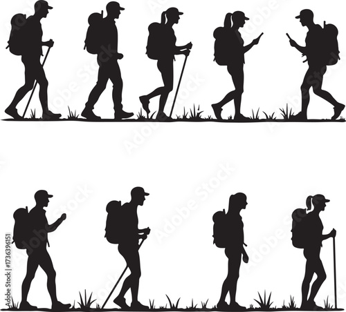 Silhouette hikers with backpacks and walking sticks on grass