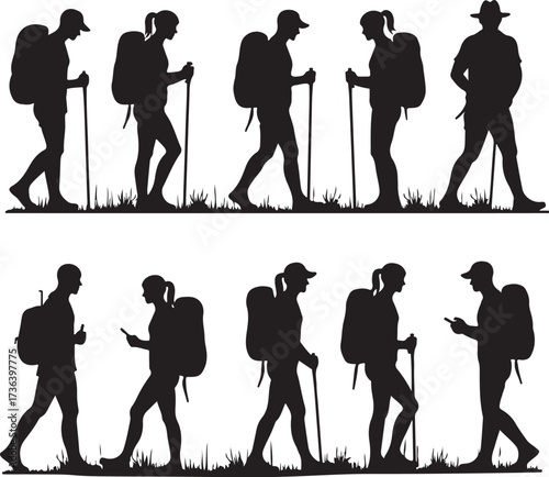 Silhouette hikers with backpacks and walking sticks on grass
