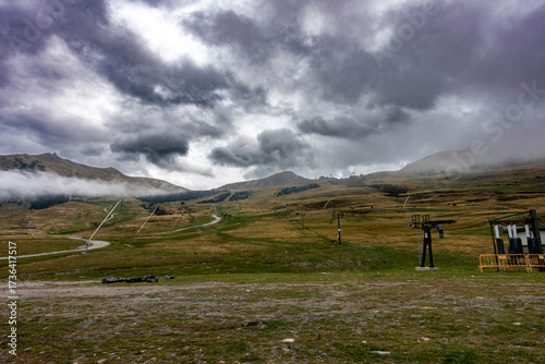 An empty ski resort during the off-season under a dramatic and stormy sky in Baqueira-Beret, Spanish Pyrenees