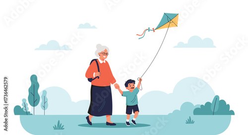 An elderly woman and a young boy are walking in a park flying a kite.