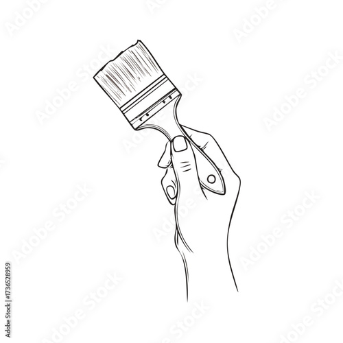 A hand holding a paintbrush, ready to create. The hand delicately grips the paintbrush, poised to bring a fresh coat of color to any surface