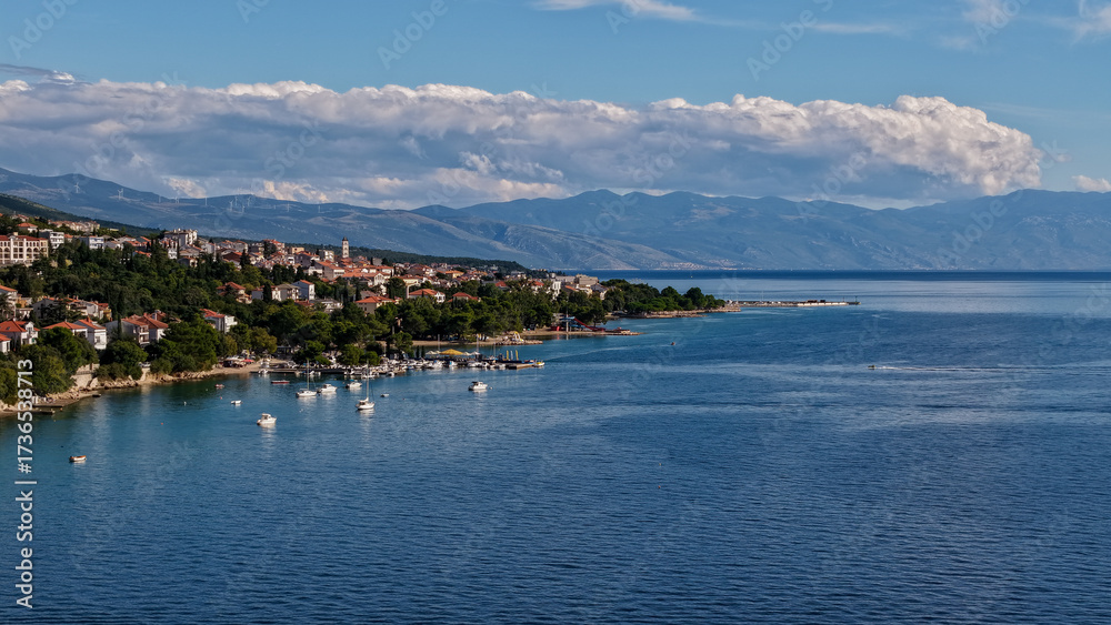Fototapeta premium Aerial drone view of Crikvenica and Dramalj with turquoise Adriatic Sea, green-blue waters, beaches, and the island of Krk in the distance. Taken on 27.09.2025 in Dramalj, Croatia.