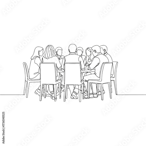 Group of people sitting around a table in a meeting.