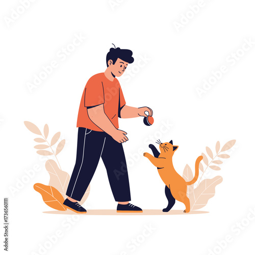 A young man is playing with his cat in a park with plants around him.