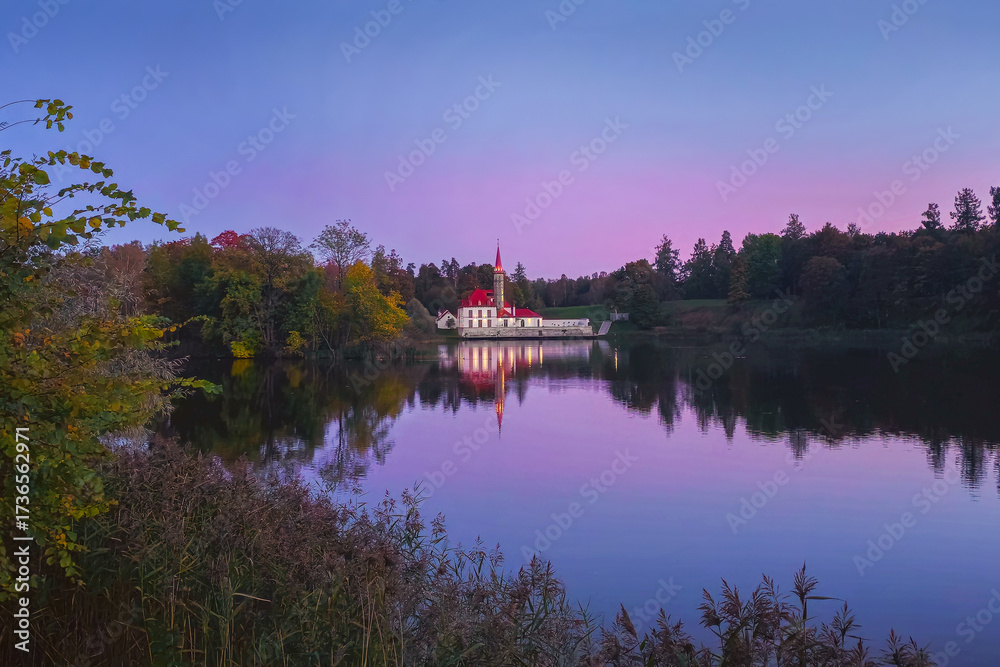 Fototapeta premium The Priory Palace during purple sunset. Gatchina.