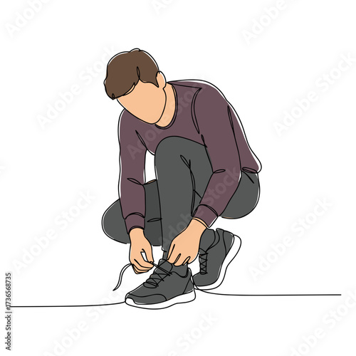 Man tying shoelaces while crouching on the floor in casual attire  