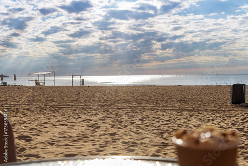Beautiful sandy beach with gentle waves under a clear blue sky. The serene coastal scene captures the essence of summer, relaxation, and natural beauty. Perfect for themes of travel, vacation, seaside