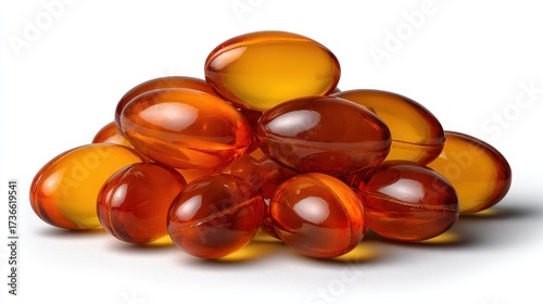 Pile of translucent amber colored gel capsules on a white background