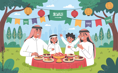 Family celebrating outdoors with Saudi flags and food