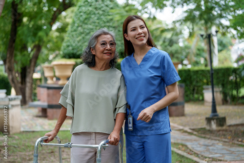 Quadro em tela Caregiver provides assistance and support to senior in park, showcasing importan