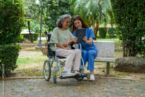 Tableau sur toile Caring caregiver provides assistance and support to senior in wheelchair while enjoying moment together outdoors