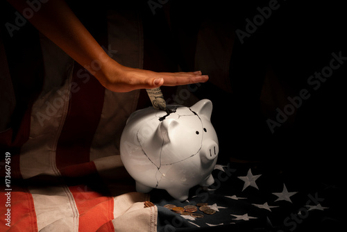 Tween Female Hands Pressing Piggy Bank on U.S. Flag – Budget Pressure