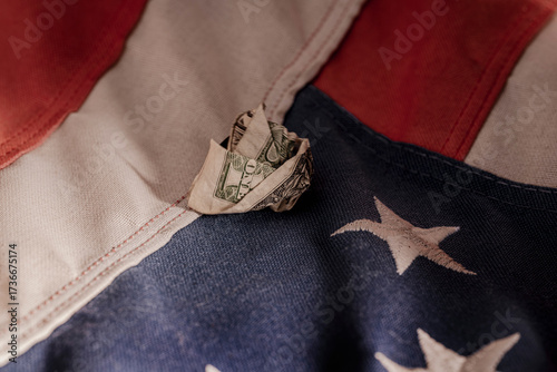 Crumpled Dollar Bill on U.S. Flag – Symbol of Fragile Economy