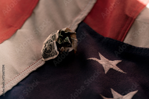 Wrinkled Dollar Across American Flag – Fragile Economy Concept