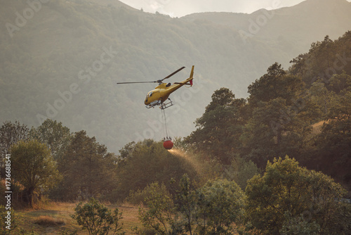 Yellow helicopter firefighting mission in spanish valley