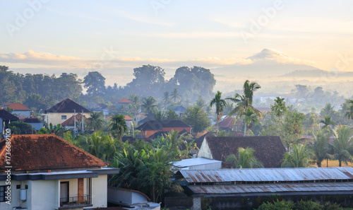 Mountain range is visible in the background of a town with houses