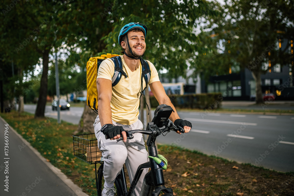 Fototapeta premium Food delivery courier riding bicycle in city