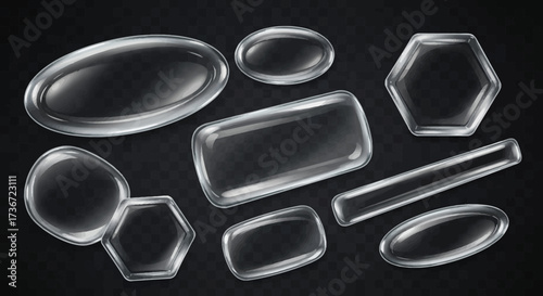 A Collection of Various Transparent Trays and Platters in Different Shapes and Sizes Showing Their Shiny Surfaces Against a Dark Background with a Subtle Grid Pattern