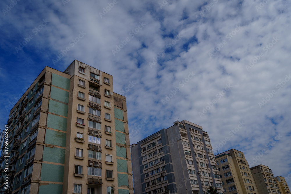 Naklejka premium A row of pastel apartment blocks under cloudy sky