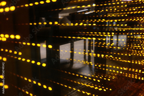 Yellow lights glow, abstract art in the dim.
