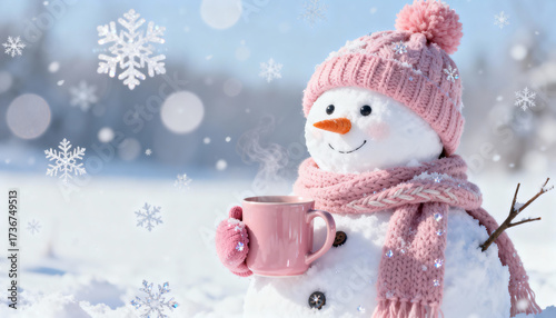 Cheerful snowman wearing pink winter accessories holding a steaming mug in snowy landscape with falling snowflakes
