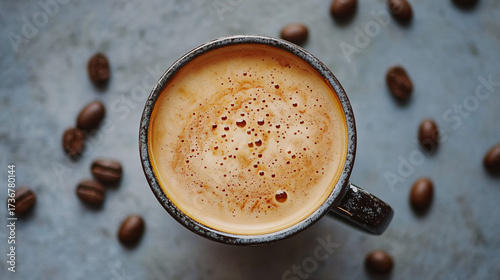 A cup of coffee with beans and latte art in a cafe atmosphere
