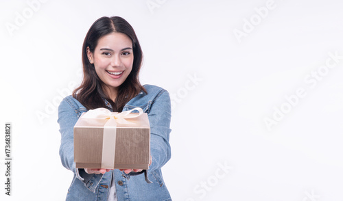 Cheerful asian woman use finger make mini heart showing glod gift box smiling over isolated white background. Concept happiness and joy, as young girl excited give gift someone. Gift box surprise.