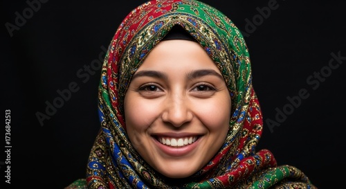 Wallpaper Mural Radiant smile of a young muslim woman in a colorful hijab against a dark background Torontodigital.ca