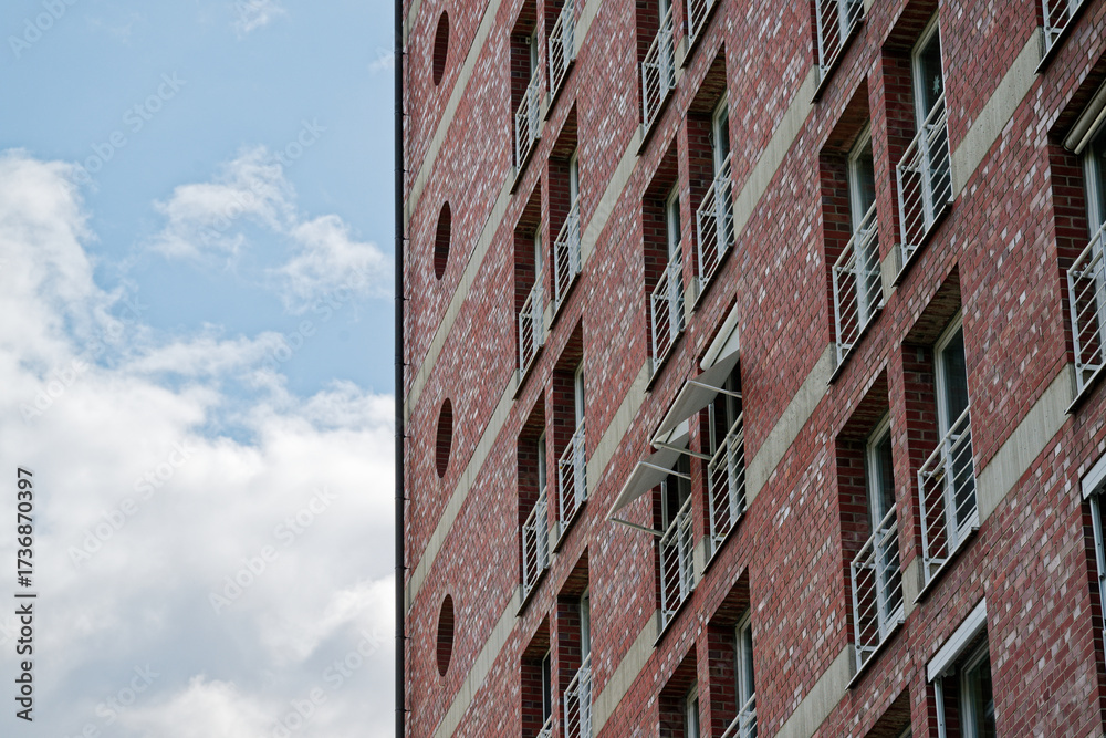 Fototapeta premium Brick building under construction with tiny door balconies