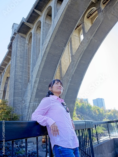  Woman under the bridge enjoys the view.