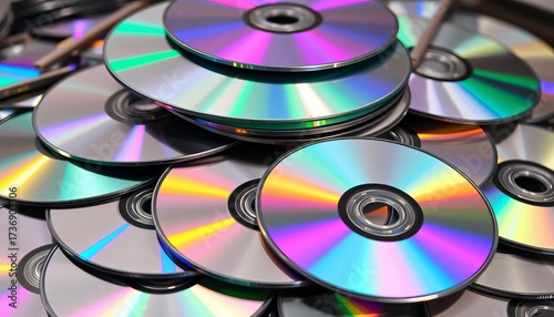 A haphazard stack of various CDs, some scratched, others pristine,  messy,  background