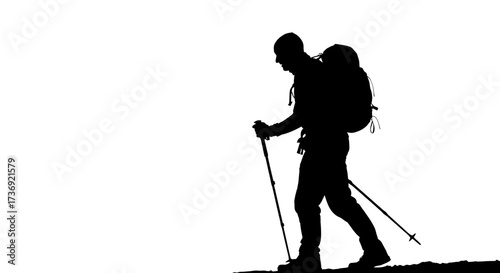 Silhouette of a lone hiker with a backpack and trekking poles walking on a rocky surface against a white background