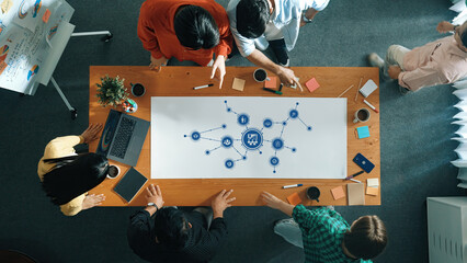 Collaborative Management Session with Strategic Planning and Visual Diagrams on a Conference Table with Diverse Team Members. Amity