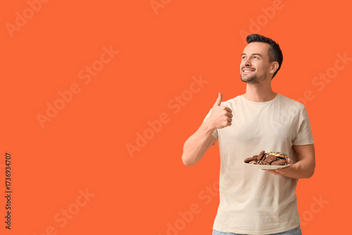 Handsome man with plate of ...