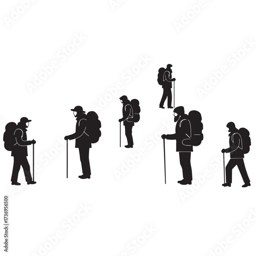 Group of hikers with backpacks and poles standing silhouette