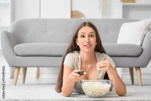 Young woman with remote con...