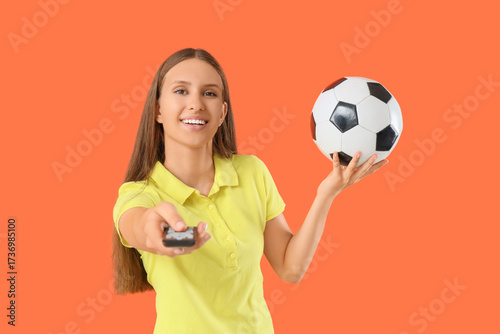 Young woman with TV remote ...