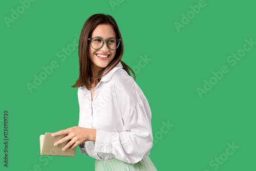 Smiling young woman in gree...