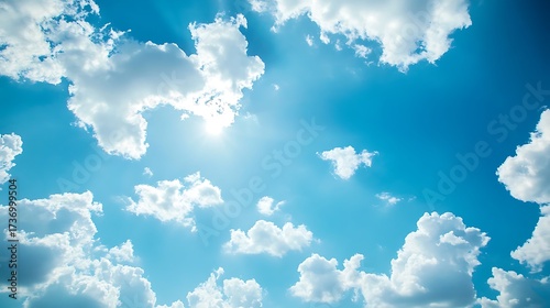 Bright Sun Shining Through Fluffy White Clouds in a Vibrant Blue Sky