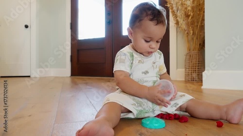 Adorable Baby Exploring Fruit Container in Bright Home Interior