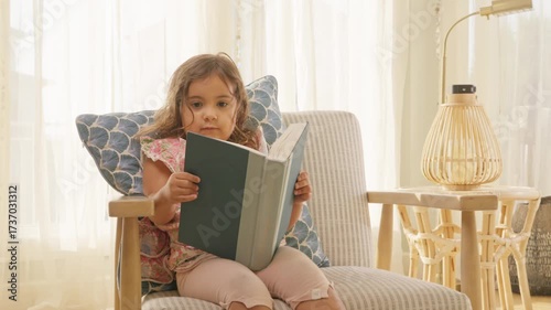 Young Kid Reading Indoors in Sunlit Family Living Room
