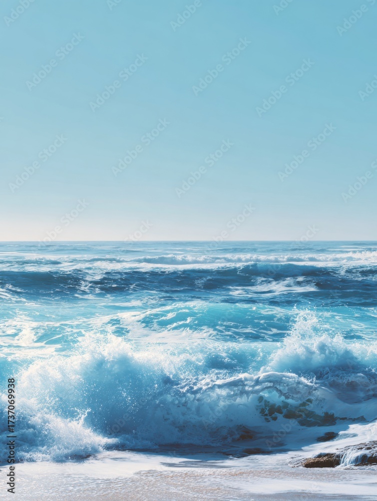 Obraz premium Waves Crashing on a Serene Beach With Clear Blue Skies on a Sunny Day