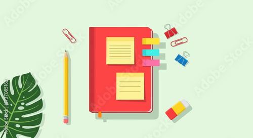 Office supplies flatlay notebook, pencil, clips, and sticky notes on a light green surface