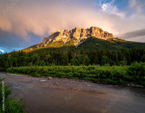 Mountain peak at sunset over a river