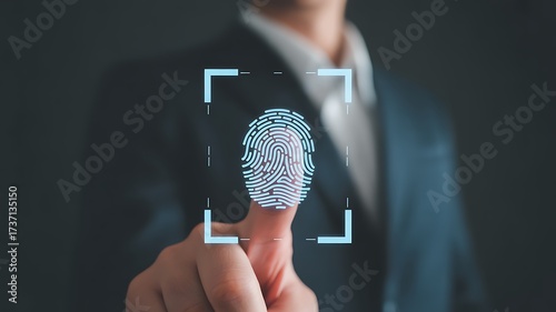 Blue fingerprint scan icon on virtual screen while finger scanning for security access with biometrics identification on dark.