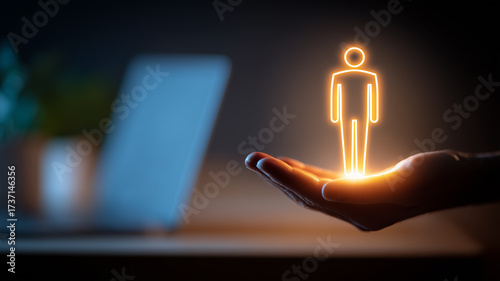 Glowing human figure above a hand embodying customer centric design and personalized support within modern digital work.
