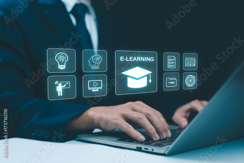 Businessman using laptop with virtual e-learning icons, online education concept, digital training, remote learning, and technology innovation for modern study, knowledge, and professional development