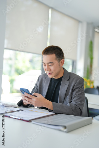 Asian Businessman with Smartphone working mobile devices cell telephone technology e-commerce smartphone business professional investor working new start up project