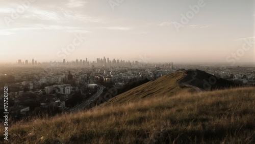 Panoramic cityscape view from a hilltop at sunset