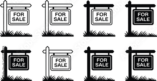 Collection of "For Sale" Real Estate Signs on Posts with Grass